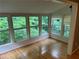 Bright sunroom featuring hardwood floors and abundant natural light from multiple windows at 5147 Roswell Rd # 9, Atlanta, GA 30342