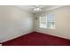 Bright bedroom featuring a ceiling fan and large window with blinds at 6955 Pompas Ct, Douglasville, GA 30135