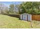 Fenced backyard featuring a storage shed on a lush green lawn, perfect for outdoor activities at 85 Lawson St, Buford, GA 30518