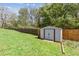 Fenced backyard featuring a storage shed on a lush green lawn, perfect for outdoor activities at 85 Lawson St, Buford, GA 30518