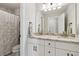 Bright bathroom features a double vanity with granite countertop and a shower with marble tile at 85 Lawson St, Buford, GA 30518