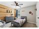 Cozy bedroom with wood accent wall, dresser and charming decor at 85 Lawson St, Buford, GA 30518