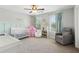 Charming Bedroom featuring a crib, glider and soft pastel accents at 85 Lawson St, Buford, GA 30518