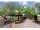 Spacious outdoor deck includes seating, grilling area, and wooded views at 85 Lawson St, Buford, GA 30518