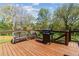 Outdoor deck features seating area, grilling station, and backyard views at 85 Lawson St, Buford, GA 30518