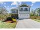 Charming two-story home featuring a front porch, two car garage and a fenced in yard at 85 Lawson St, Buford, GA 30518