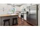 Stylish kitchen featuring white cabinets, stainless steel appliances, butcher block island, and modern fixtures at 85 Lawson St, Buford, GA 30518
