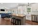 Open concept kitchen with white cabinets, stainless steel appliances, a butcher block island, and dining area at 85 Lawson St, Buford, GA 30518