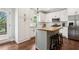 Bright kitchen with white cabinets, stainless steel appliances, and a butcher block island with seating at 85 Lawson St, Buford, GA 30518