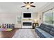 Well-lit living room featuring a modern fireplace and an entertainment area at 85 Lawson St, Buford, GA 30518