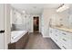 Bright main bathroom featuring soaking tub, tiled walk-in shower, and double vanity at 85 Lawson St, Buford, GA 30518