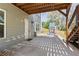 Covered patio with access to backyard play area, complete with stairs and space for entertaining at 85 Lawson St, Buford, GA 30518
