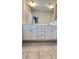 The primary bath has double sinks, large mirror, and tile flooring at 2102 Talmai Dr, Snellville, GA 30078