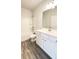 Bathroom with wooden vinyl floor, white cabinets and bathtub at 2102 Talmai Dr, Snellville, GA 30078
