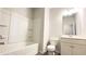 Bright bathroom featuring a shower and tub combination with white fixtures and a single sink vanity at 2102 Talmai Dr, Snellville, GA 30078