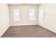Bright, carpeted bedroom with two windows and neutral walls at 2102 Talmai Dr, Snellville, GA 30078