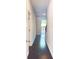 Long entryway with gleaming hardwood floors and natural light from the open doorway at 2102 Talmai Dr, Snellville, GA 30078