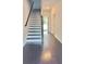 Inviting entryway showcasing dark wood floors and a staircase with black and white risers at 2102 Talmai Dr, Snellville, GA 30078