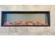 Modern electric fireplace with stone surround at 2102 Talmai Dr, Snellville, GA 30078