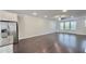 Spacious open-concept living area with stainless steel appliances and dark hardwood floors at 2102 Talmai Dr, Snellville, GA 30078