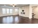 Open living room with a ceiling fan, windows, and a fireplace at 2102 Talmai Dr, Snellville, GA 30078