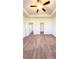 Spacious carpeted primary bedroom with ceiling fan, walk in closet, and ample natural light at 2102 Talmai Dr, Snellville, GA 30078
