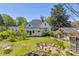 Backyard featuring a charming home with an upper porch, surrounded by a lush, green yard with play equipment at 215 Fair St, Loganville, GA 30052