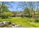 Expansive backyard with lush lawn and mature trees, showing the home's potential for outdoor living at 215 Fair St, Loganville, GA 30052