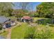 Expansive backyard featuring a rustic cottage, a charming play area, and mature trees for shade at 215 Fair St, Loganville, GA 30052