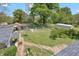 Overhead shot of backyard with mature trees, an outdoor seating area, and storage sheds at 215 Fair St, Loganville, GA 30052