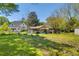 View of the expansive backyard, showcasing a potential garden and the charming outbuildings at 215 Fair St, Loganville, GA 30052