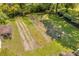 Aerial view of a verdant backyard featuring garden rows, tool shed, and ample space for outdoor enjoyment at 215 Fair St, Loganville, GA 30052