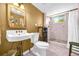 Bathroom featuring a vanity sink, toilet, and tiled walk-in shower with a window at 215 Fair St, Loganville, GA 30052