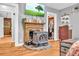 Charming bedroom boasts a decorative fireplace with TV and a peek into the organized walk-in closet at 215 Fair St, Loganville, GA 30052