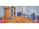 Bedroom with hardwood floors, wardrobe, dresser, baskets, and various storage containers at 215 Fair St, Loganville, GA 30052