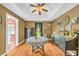 Traditional dining room features hardwood floors, a tray ceiling, and classic furnishings at 215 Fair St, Loganville, GA 30052