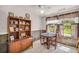 Dining room boasts natural light, a storage unit, and a rustic ceiling fan at 215 Fair St, Loganville, GA 30052