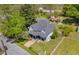 Charming home with inviting front porch and stone pathway, surrounded by mature trees, offering great curb appeal at 215 Fair St, Loganville, GA 30052