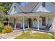 Charming front porch with a swing, inviting decor, and classic architectural details at 215 Fair St, Loganville, GA 30052