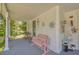 Cozy front porch with a pink bench, a charming swing, and delightful decorative touches at 215 Fair St, Loganville, GA 30052
