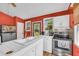 Bright kitchen features white cabinets and a view of the backyard at 215 Fair St, Loganville, GA 30052