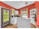 Bright kitchen with white cabinets, tile counters, appliances, and a view of backyard at 215 Fair St, Loganville, GA 30052