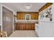 Well-lit kitchen shows wooden cabinets, white appliances and fixtures, and functional hardware at 215 Fair St, Loganville, GA 30052