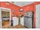 Bright laundry room features appliances, wood flooring, and access to bedroom at 215 Fair St, Loganville, GA 30052