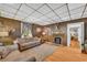 Living room showcasing a stone fireplace, hardwood floors, and comfortable seating at 215 Fair St, Loganville, GA 30052