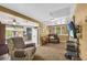 Living room featuring carpet, large windows, and comfortable seating at 215 Fair St, Loganville, GA 30052