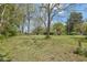 Expansive lot featuring mature trees, lush green grass, and beautiful surroundings at 215 Fair St, Loganville, GA 30052