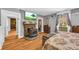 Bright bedroom featuring hardwood floors, an antique stove, and cozy decor at 215 Fair St, Loganville, GA 30052