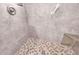 Walk-in shower featuring neutral tiles, a built-in bench, and patterned floor tiles at 215 Fair St, Loganville, GA 30052