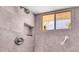 Tile walk-in shower with a built-in niche, window, and safety bar at 215 Fair St, Loganville, GA 30052